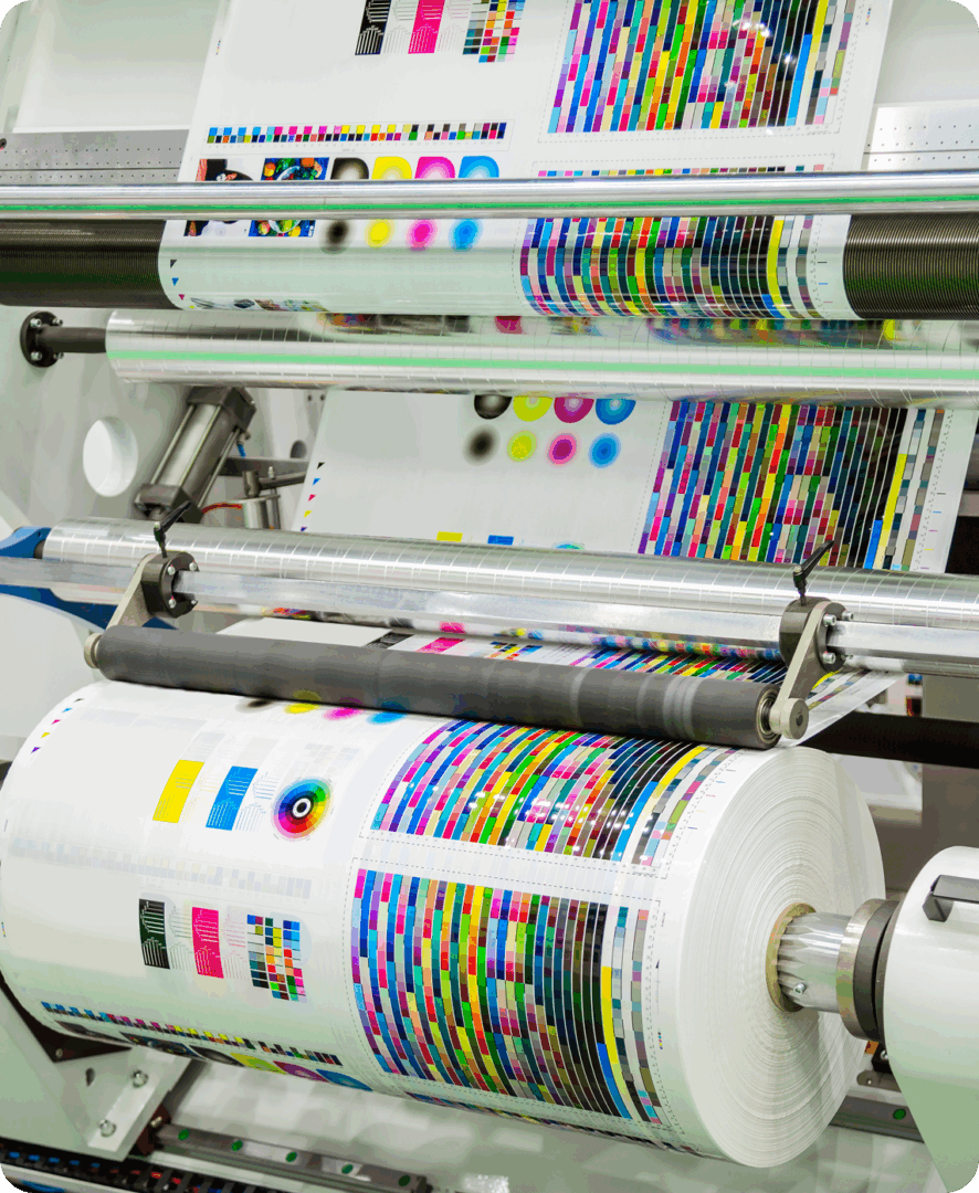 Printing machine with colorful paper rolls.